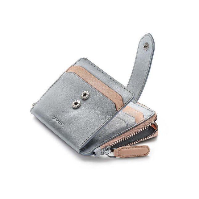 Sheaffer Expressions leather wallet in pastel blue and beige with RFID protection, card slots, and zippered compartment.