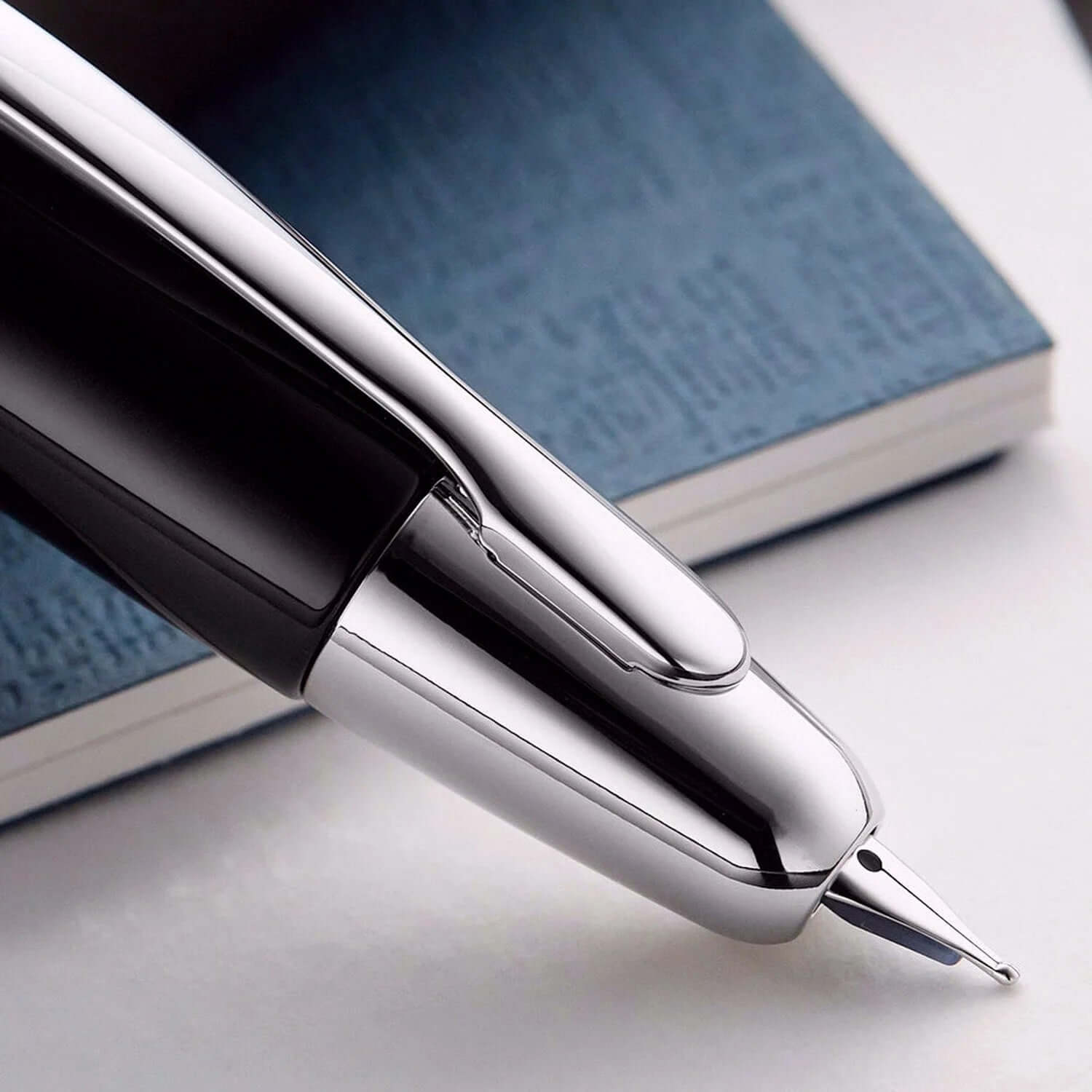 Pilot Capless Decimo Black Fountain Pen close-up with rhodium accents and nib on a notebook.
