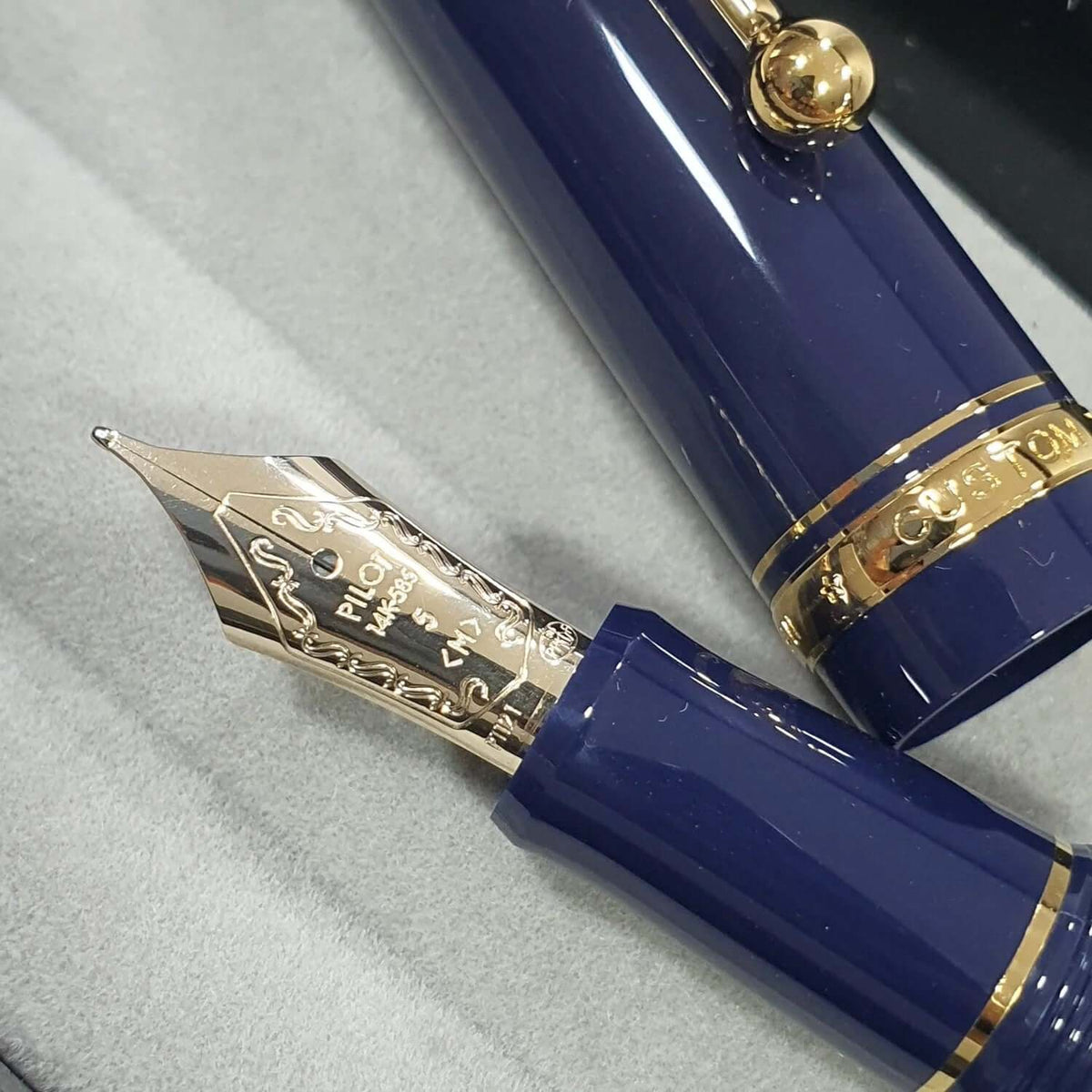 Pilot Custom 74 Dark Blue GT Fountain Pen showcasing gold nib and dark blue barrel.