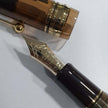 Pilot Custom 823 Amber Brown GT Fountain Pen close-up showing golden nib and barrel details.