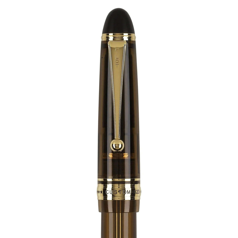 Pilot Custom 823 Amber Brown GT Fountain Pen close-up showing cap and gold trim details.