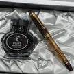 Pilot Custom 823 Amber Brown GT Fountain Pen and Pilot black ink bottle in elegant packaging.
