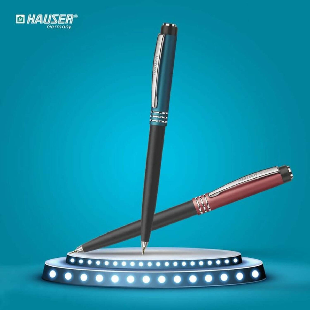 Hauser Flaunt Ball Pen | Ink Colour - Blue and red ball pens displayed under spotlight.