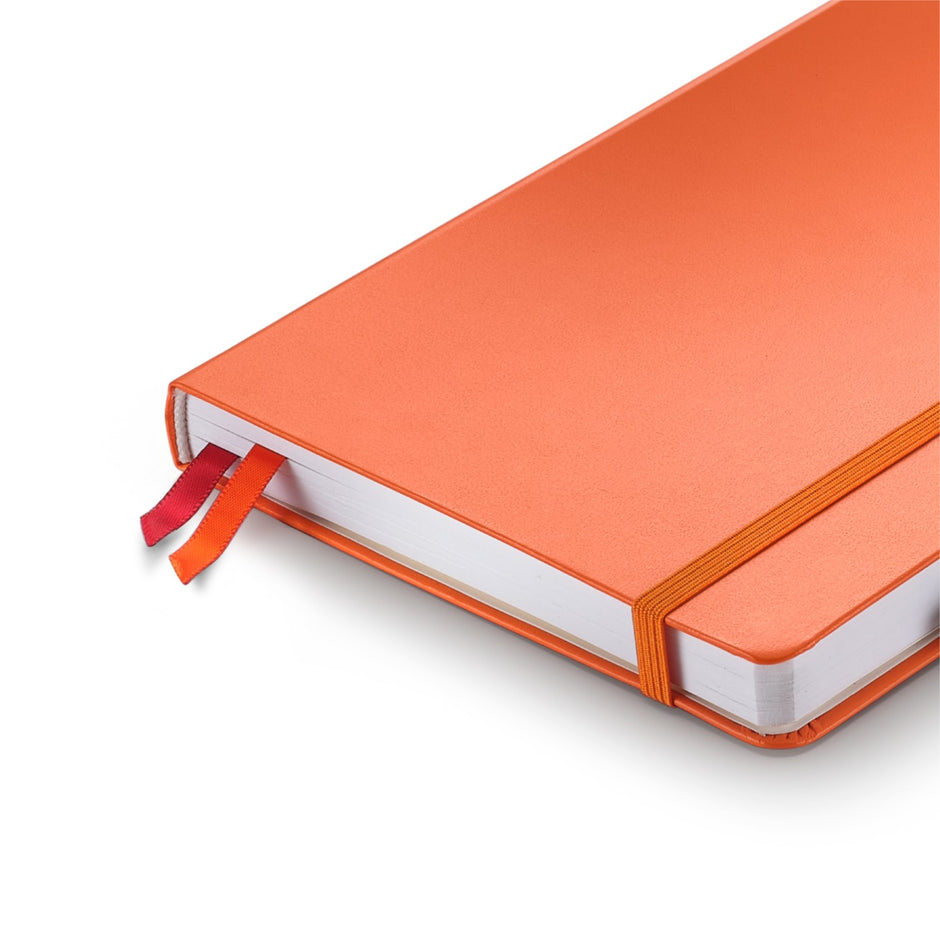 Sheaffer Echoes Of Red 90 GSM Notebook with orange hardbound cover and ribbon bookmarks.