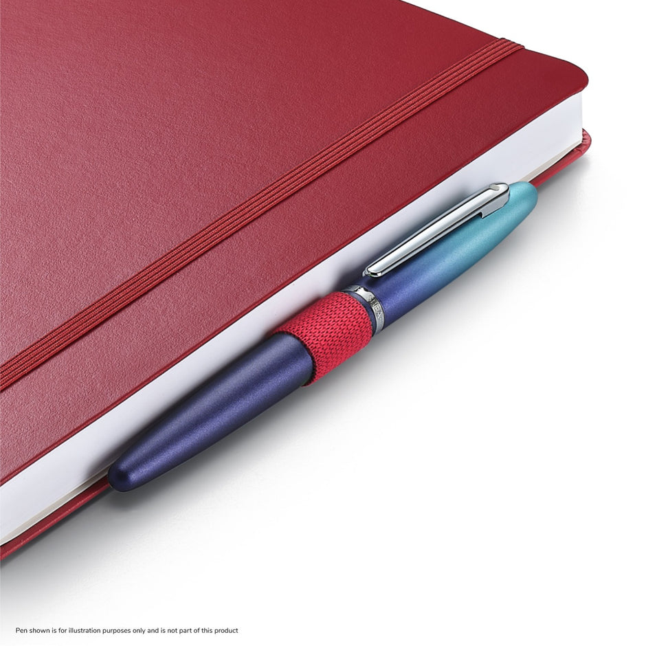 Sheaffer Echoes Of Red 90 GSM Notebook with a bold red cover and a decorative pen attached, showcasing creativity and inspiration.