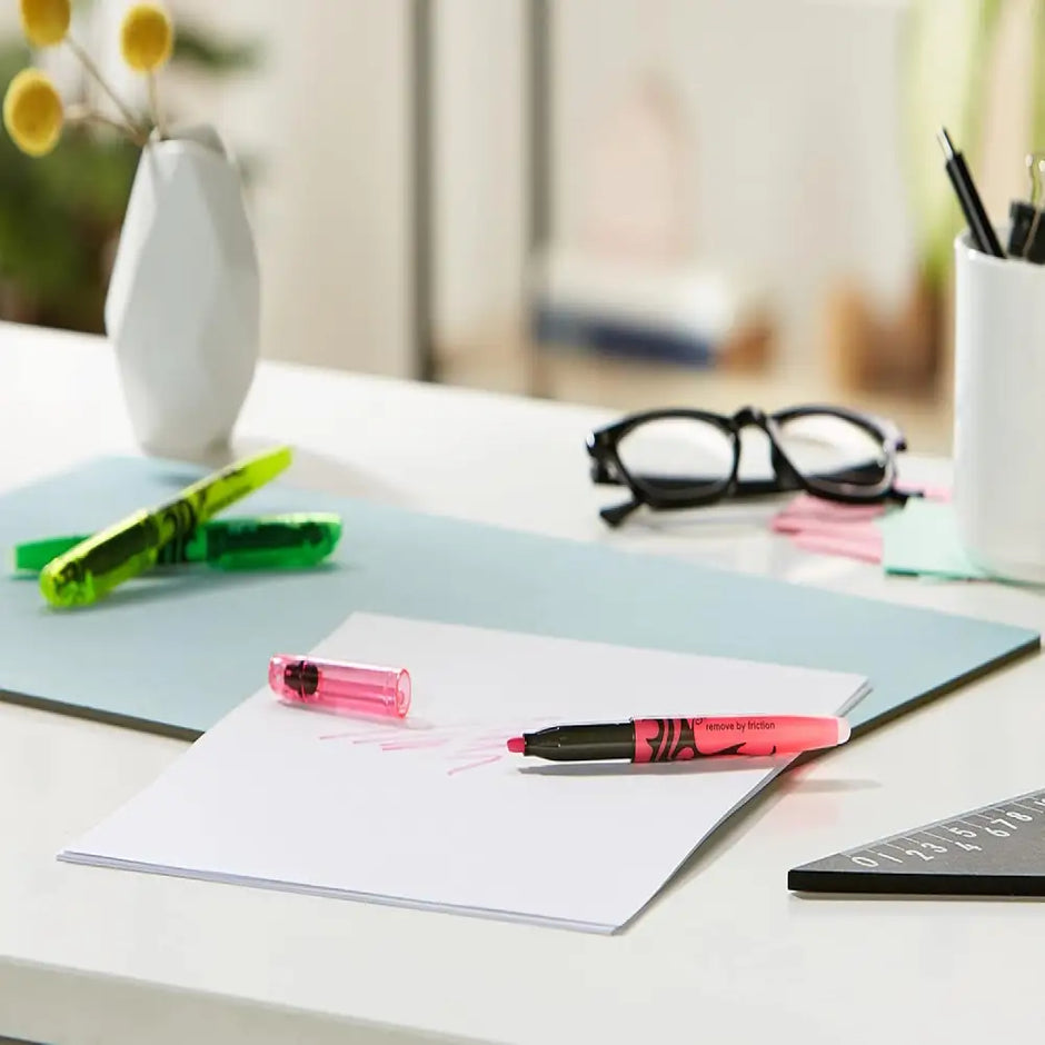 Pilot Frixion Light Highlighters Assorted Colours in pink and green on a desk with paper and accessories.