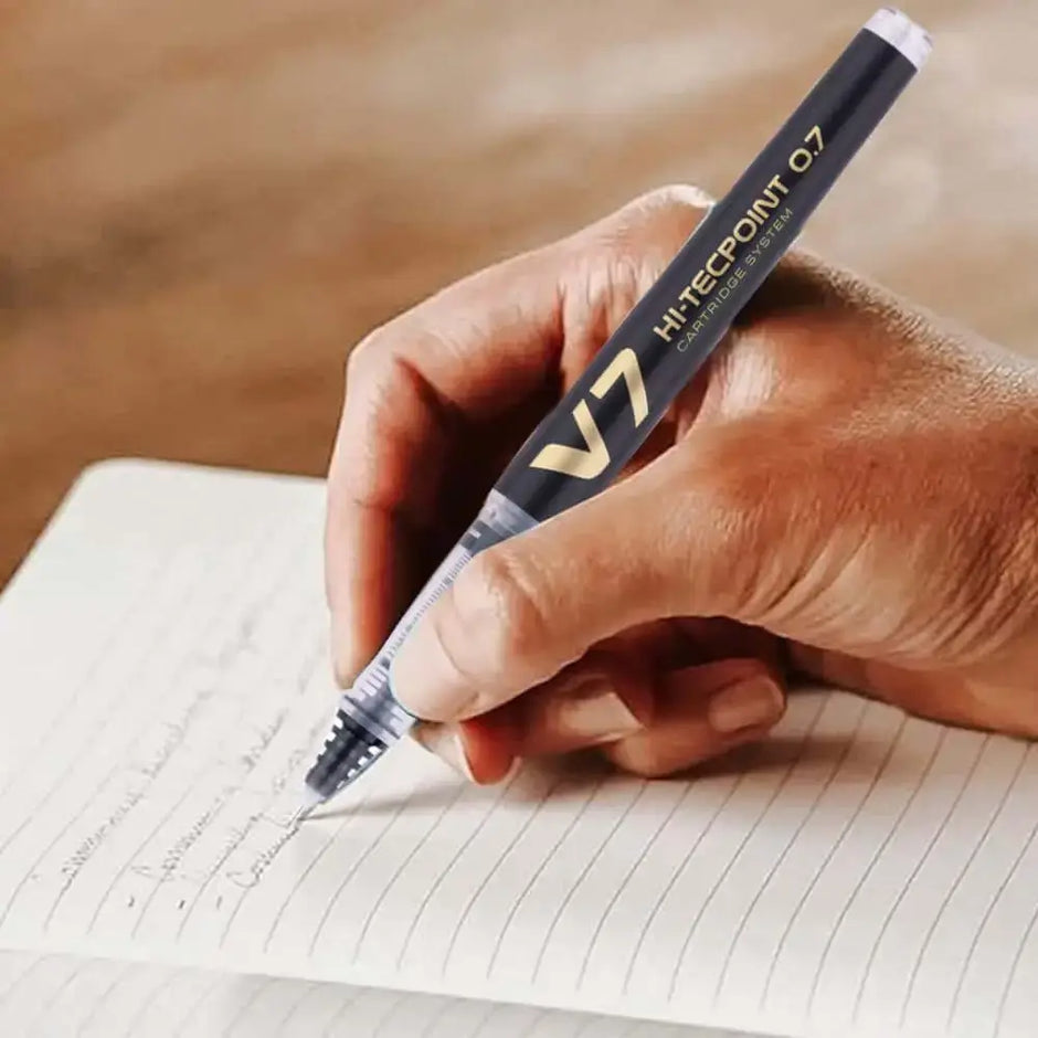 Pilot Hi-Tecpoint V7 Cartridge System 0.7mm Fine Point Roller Ball Pen in use on notebook.