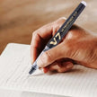 Pilot Hi-Tecpoint V7 Cartridge System 0.7mm Fine Point Roller Ball Pen in use on notebook.