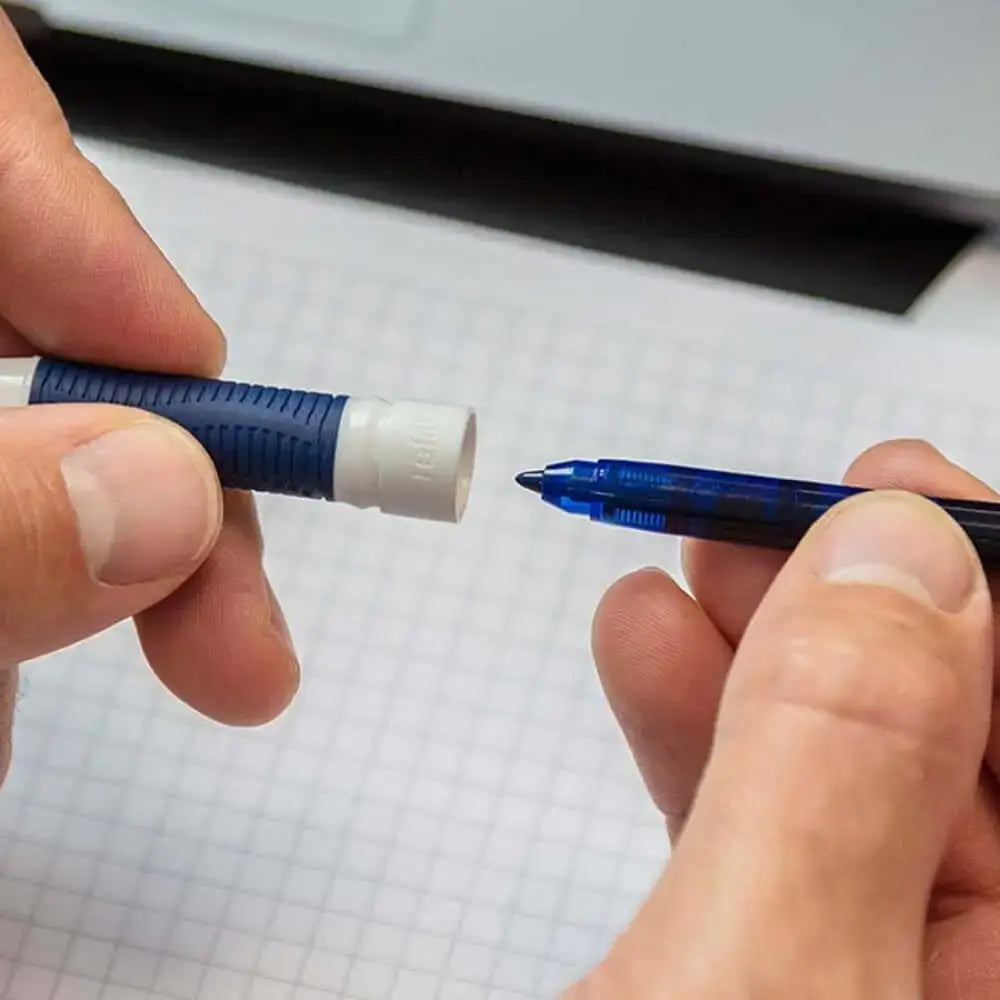 Hands holding Schneider One Change 0.6 MM Roller Ball Pen and exchangeable cartridge.