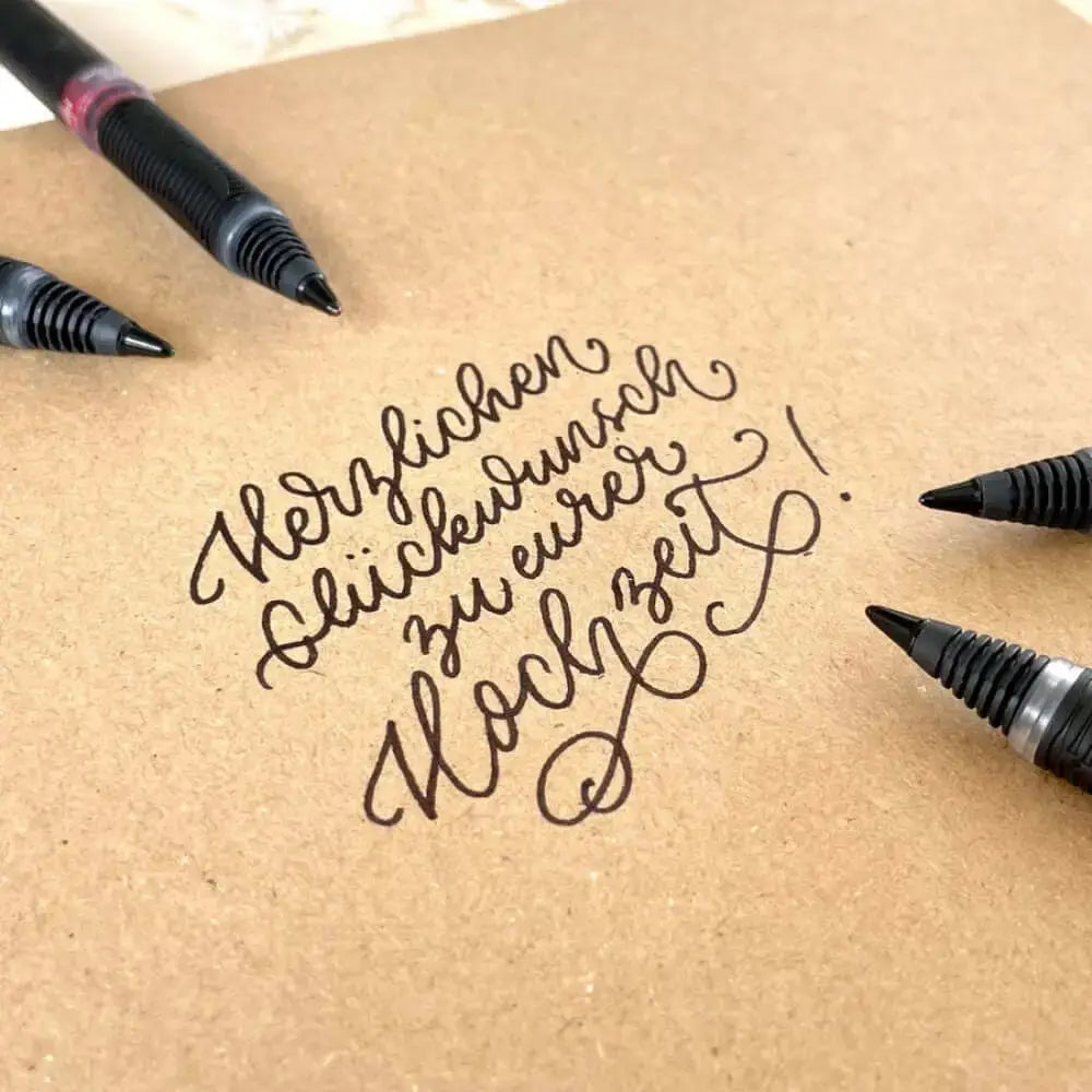 Schneider One Sign 0.8 MM Roller Ball Pen used for elegant handwriting on kraft paper for wedding wishes.