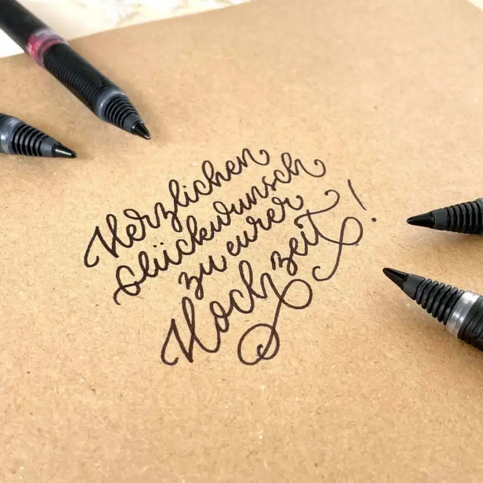 Schneider One Sign 0.8 MM Roller Ball Pen used for elegant handwriting on kraft paper for wedding wishes.