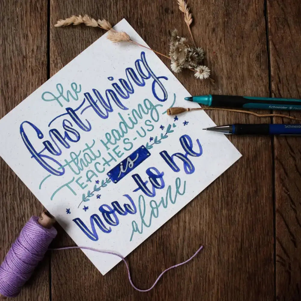 Handlettering project showcasing text created with Schneider Paint-it 020 Metallic Liner Pens on textured paper.