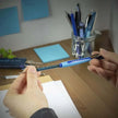 Schneider Slider Rave XB Ball Point Pen in hand, showcasing its ergonomic design and writing capabilities.